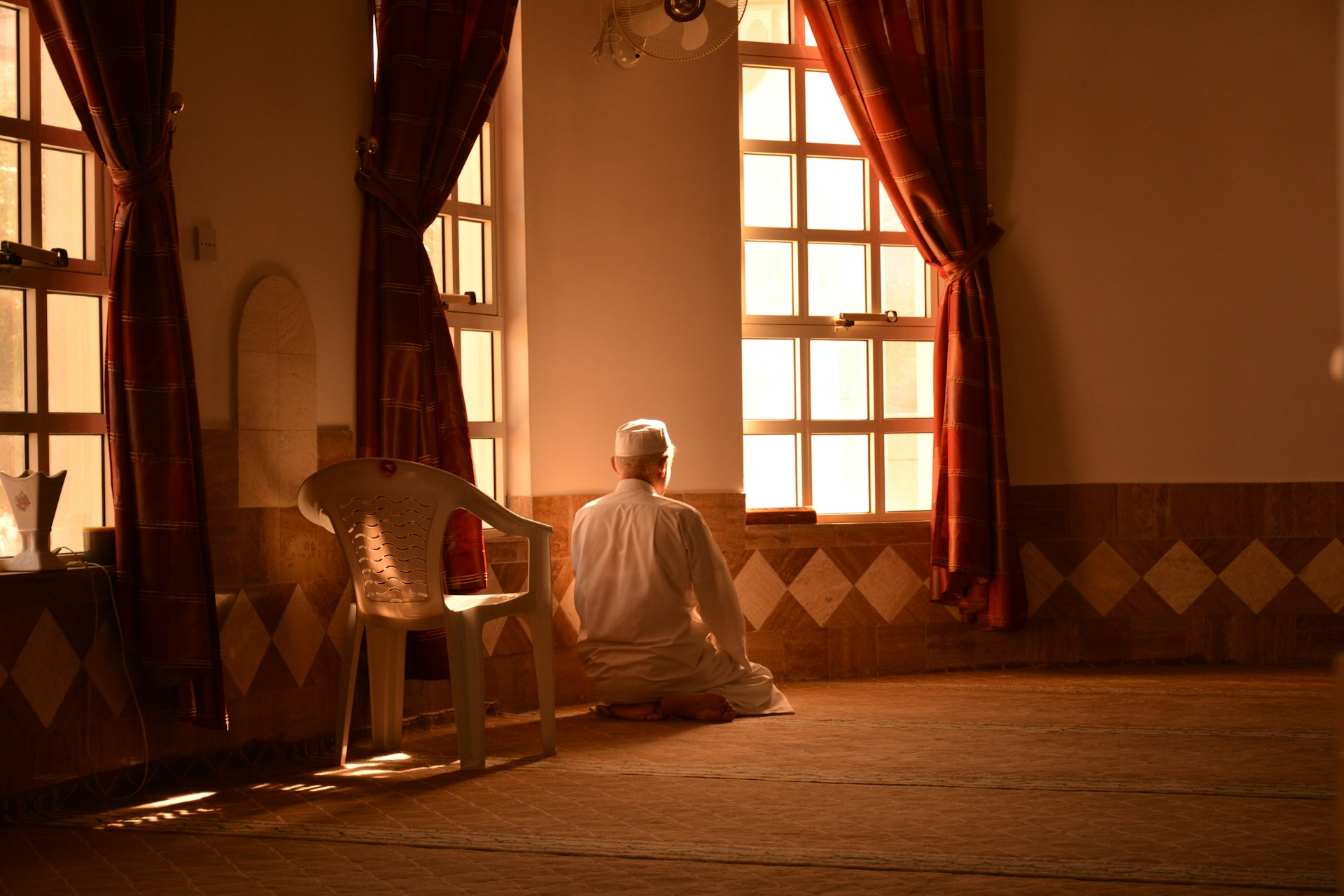 a person sitting on the floor in front of a window